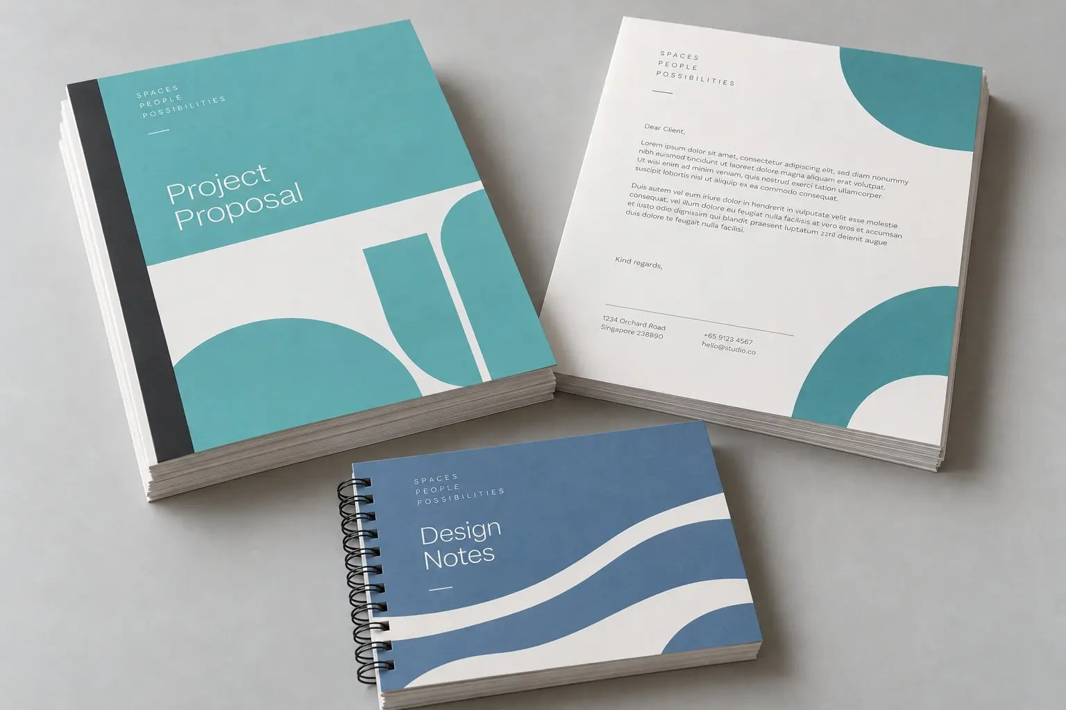 Printed and bound documents: a project proposal, a report and a spiral-bound notebook.