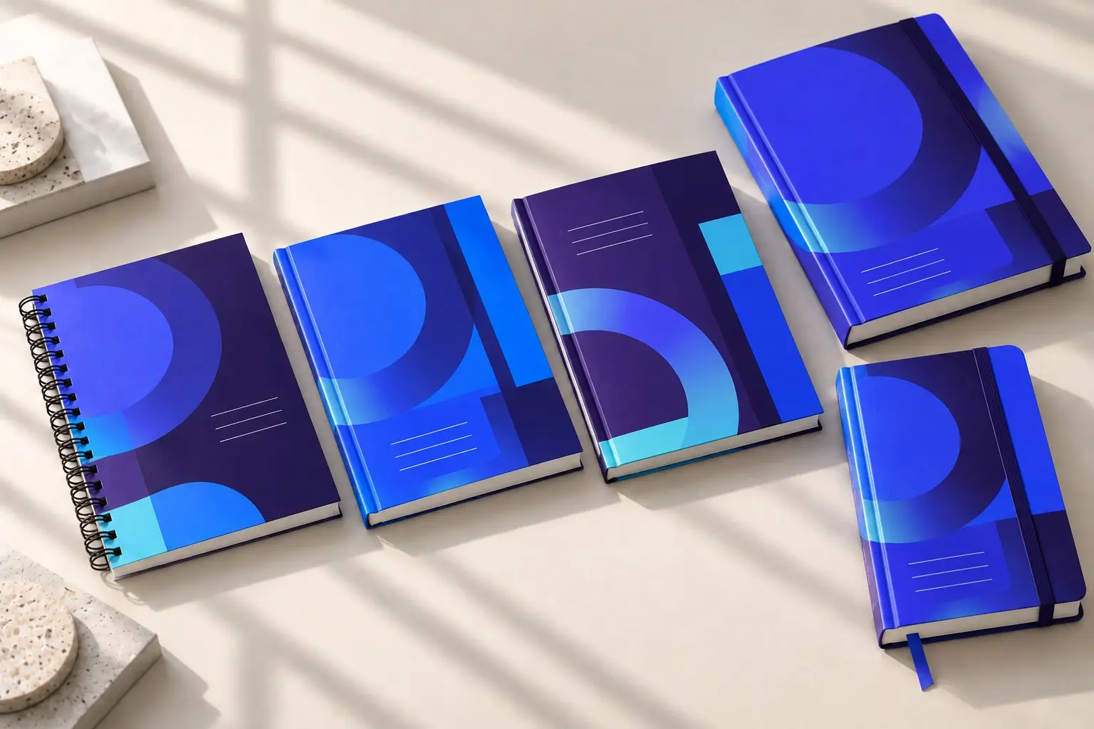 Spiral-bound and hard-cover notebooks in shades of blue.